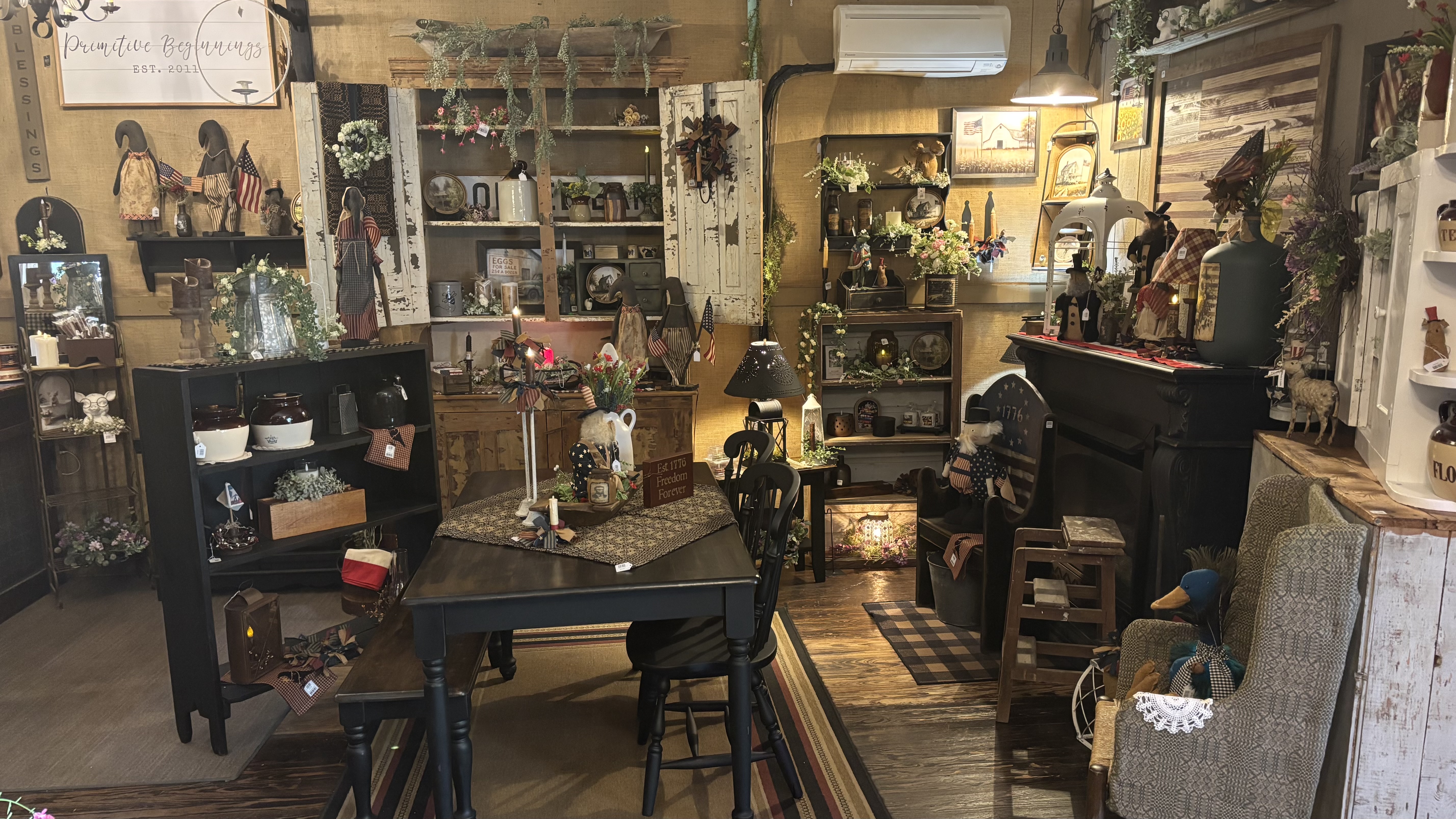 Inside Primitive Beginnings — patriotic folk art and dark wood furniture